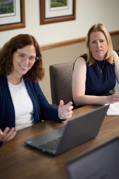 Erickson & Brooks professionals working together in a conference room